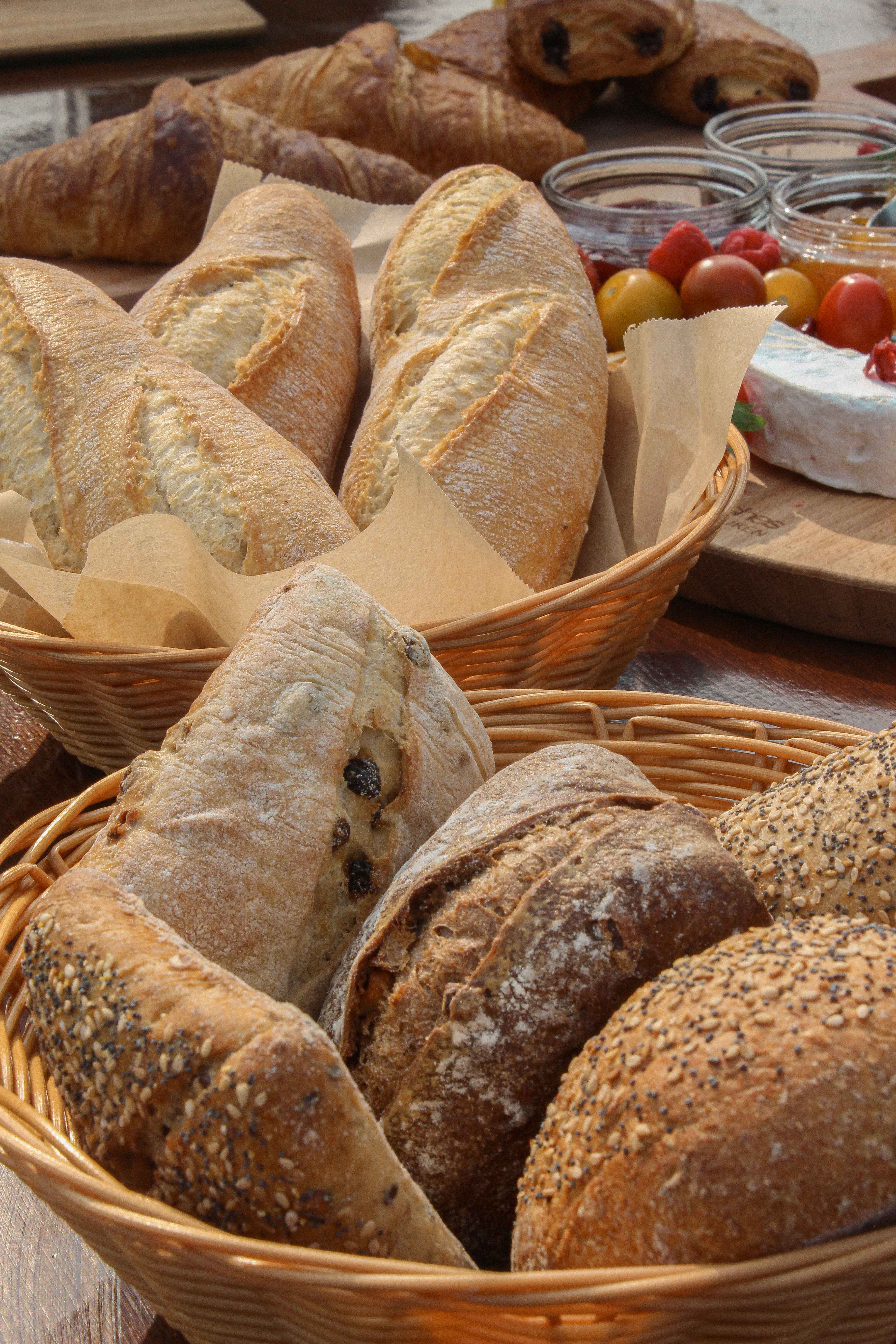 The Boat Café - Brunch & Breakfast boat with croissant, pain au chocolat, jam, butter, cheeses, ham and charuterie and breads, salads, granola bowls, coffee and juices