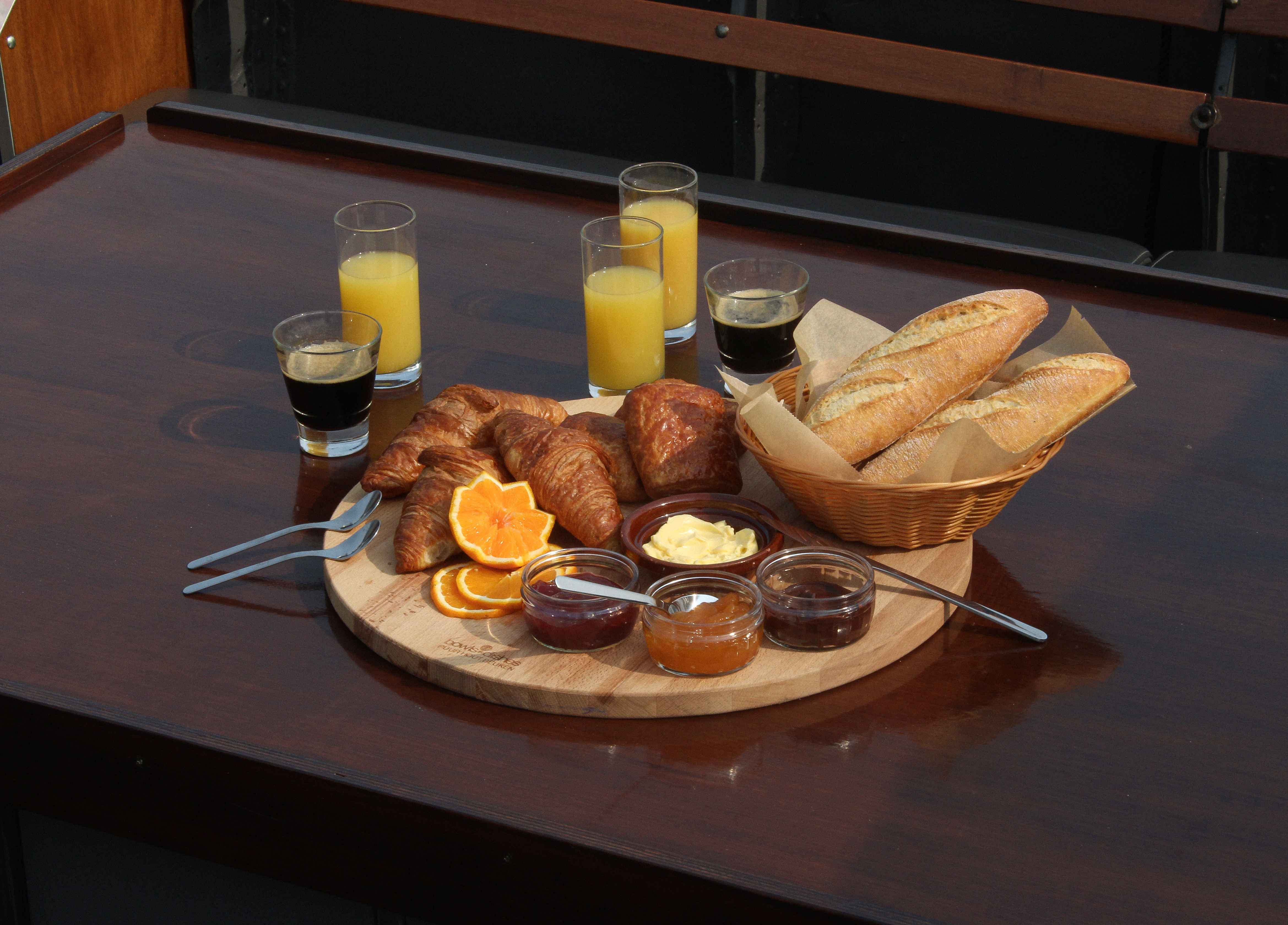 The Boat Café - Brunch & Breakfast boat with croissant, pain au chocolat, jam and butter, bread, coffee and juices