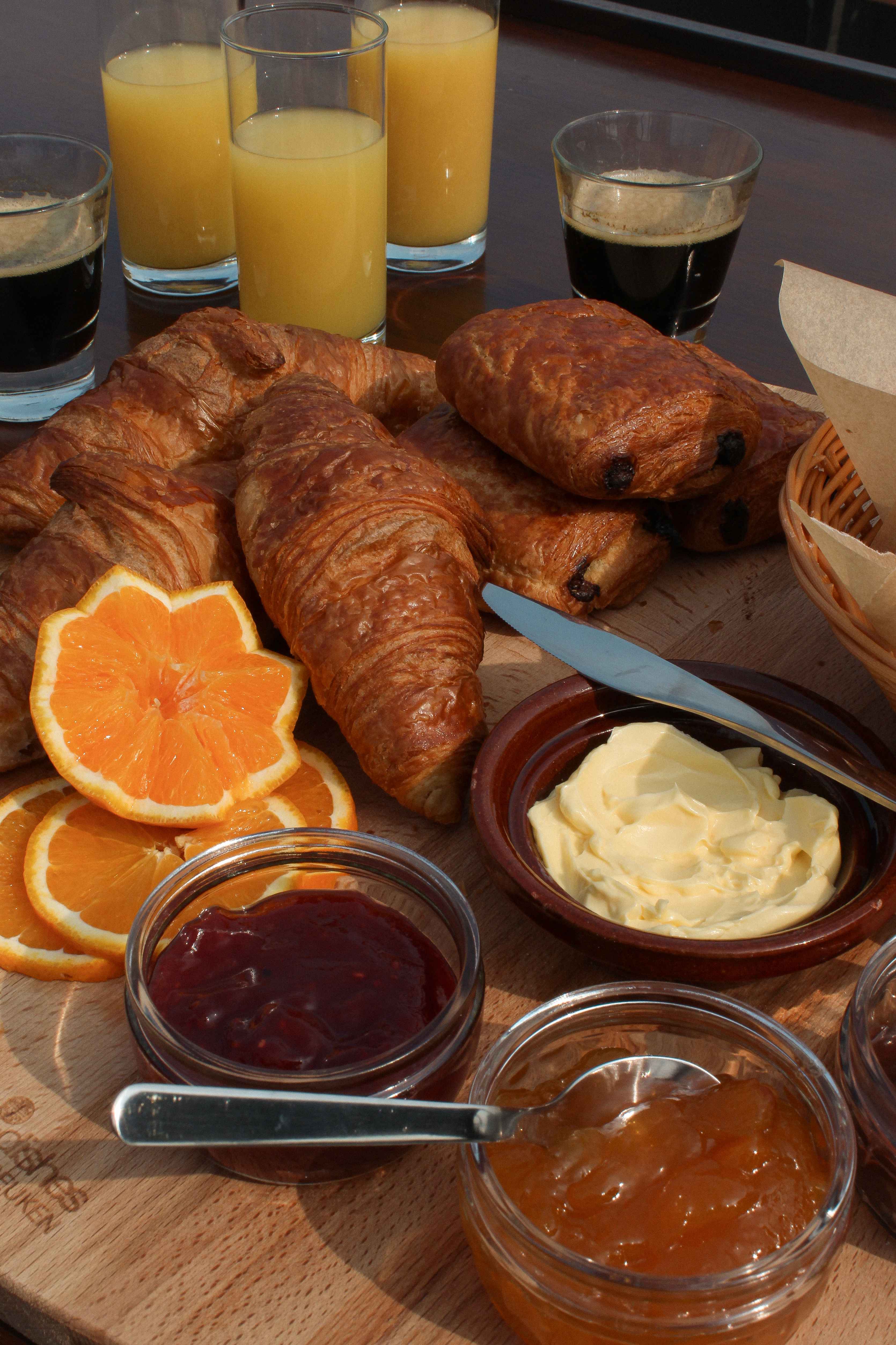 The Boat Café - Brunch & Breakfast boat with croissant, pain au chocolat, jam and butter, bread, coffee and juices